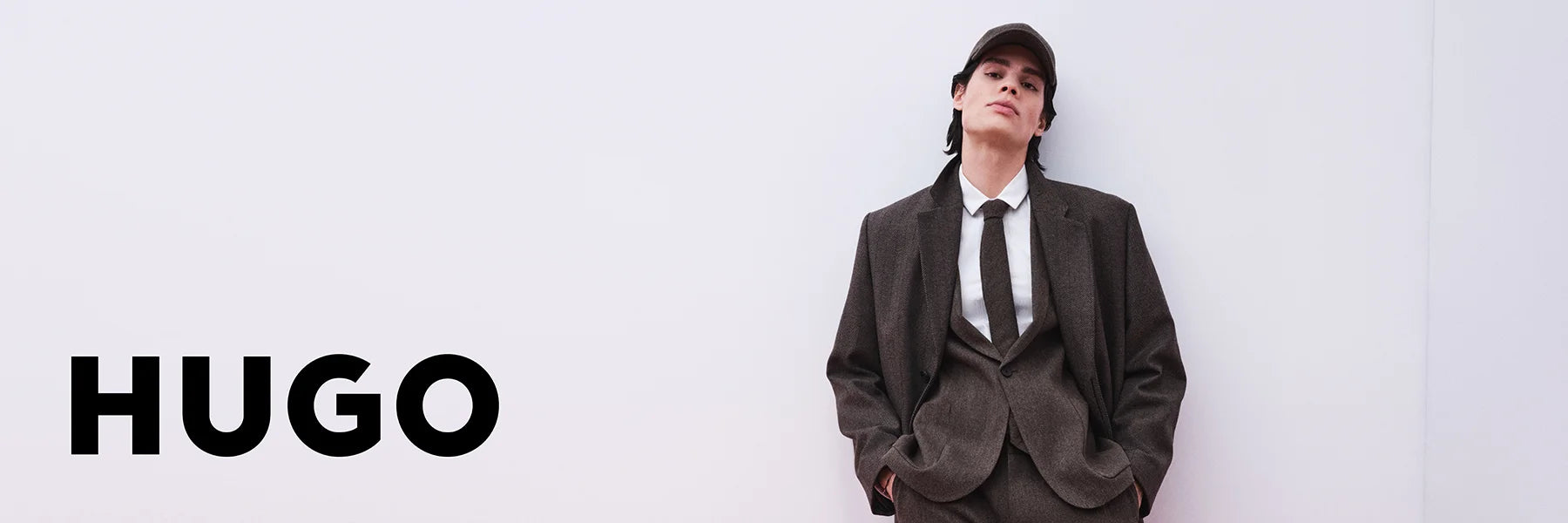 Person wearing a suit with 'HUGO' branding on a white background